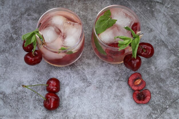 vaso de bebida fría con cereza dulce y menta