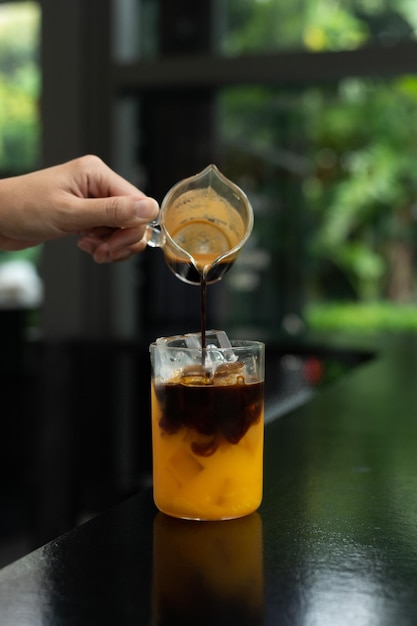 Un vaso de café helado con una cuchara vertida en él.