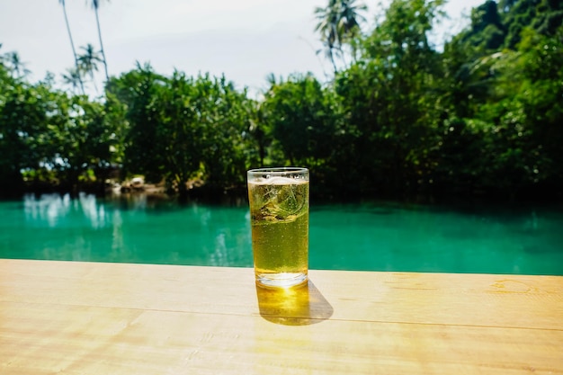 El vaso de cerveza sobre la mesa en el fondo del mar Burbujas de cerveza tailandesas llenas de hielo