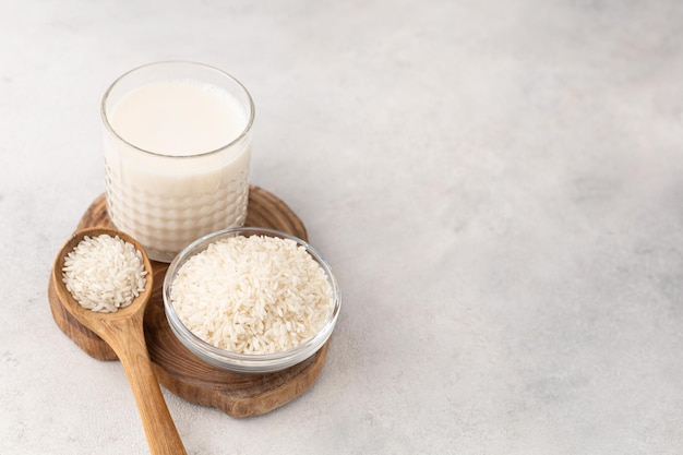 Vaso de leche de arroz con un tazón de arroz sobre un fondo claro