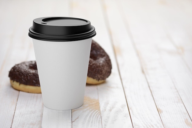 Foto vaso de papel de café desechable con donas en la mesa de madera blanca