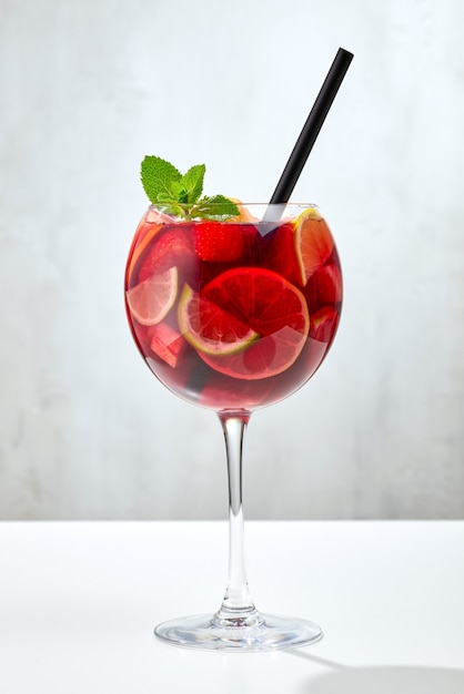 Vaso de sangría roja en mesa de restaurante gris