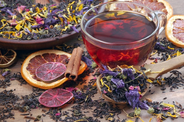 un vaso de té con un manojo de pomelo en rodajas y una cucharadita de té.