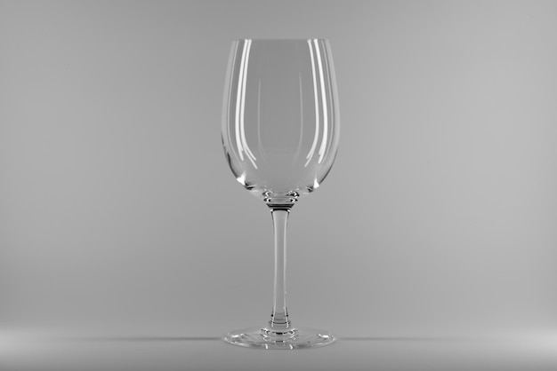 Vaso de vino vacío y limpio aislado sobre un fondo gris blanco