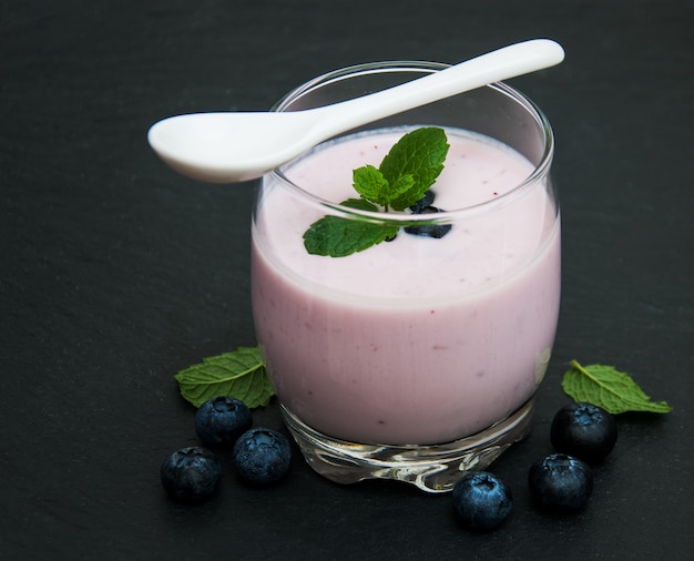 Vaso con yogur de arándanos.