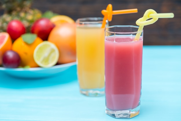 Vasos altos de jugo de fruta recién exprimido saludable