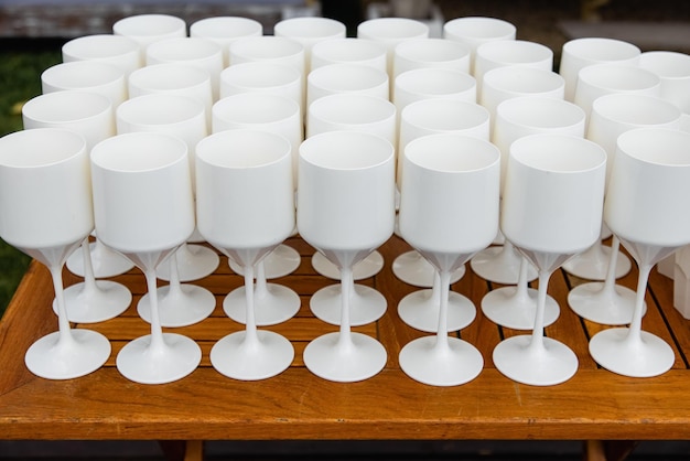 Vasos de plástico blanco para beber vino en una mesa