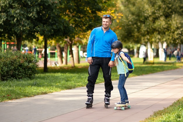 Vater bringt seiner Tochter das Skaten bei