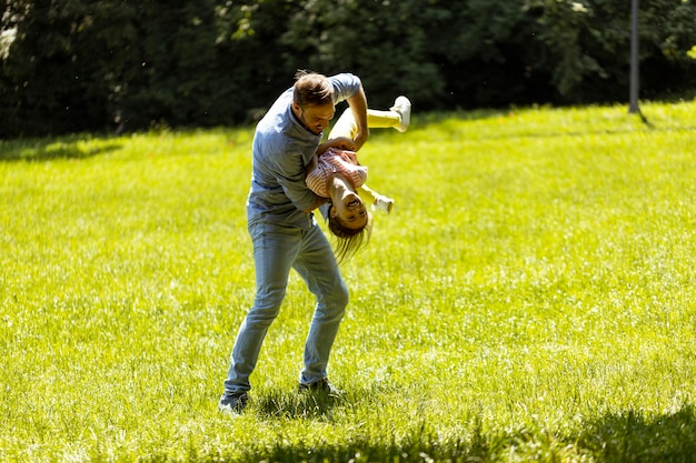 Vater mit Tochter hat Spaß auf dem Rasen im Park