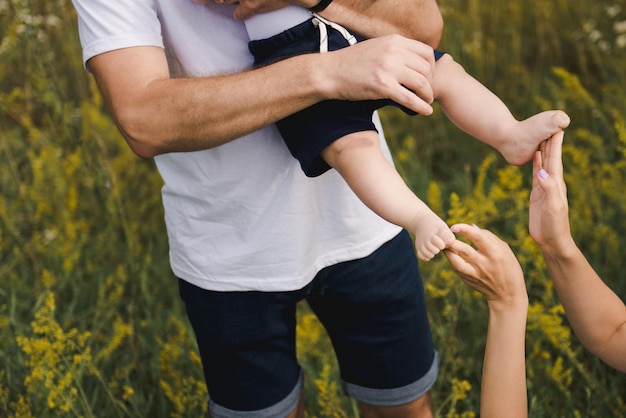 Foto vater, mutter und ihr kleiner sohn haben gemeinsam spaß auf einem weizenfeld. nahaufnahme