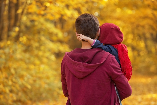 Vater umarmt Tochter am Herbsttag Kopierraum für die Rückansicht