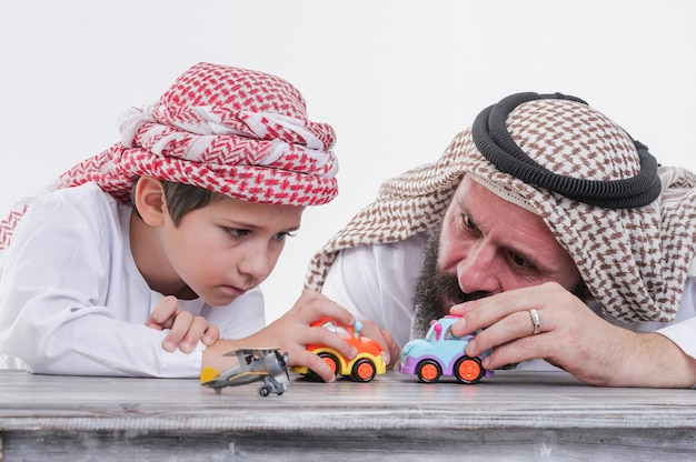 Vater und Sohn aus dem Nahen Osten spielen mit Spielzeugauto