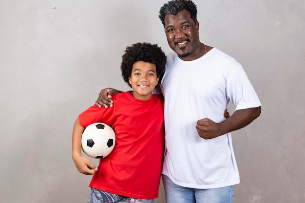 Vater und Sohn mit einem Fußball Vatertag