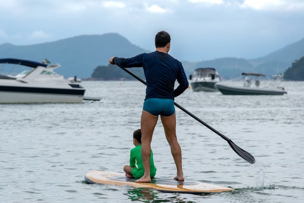 Vater und Sohn zusammen auf einem Paddle Board