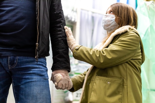 Foto vater und tochter in einem baugeschäft in medizinischen schutzmasken und einweghandschuhen