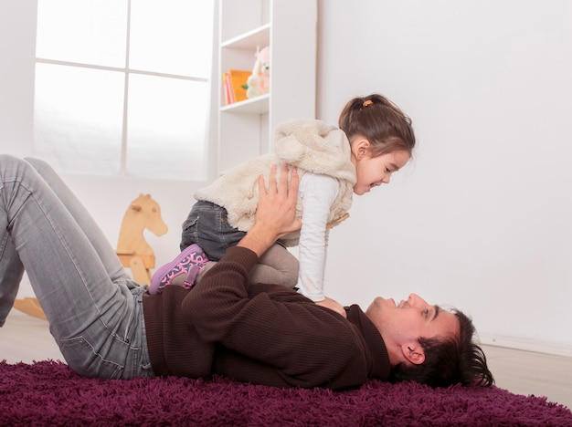 Vater und Tochter spielen im Zimmer