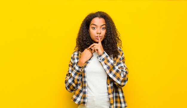 se ve serio y cruzado con el dedo presionado contra los labios exigiendo silencio o silencio, guardando un secreto