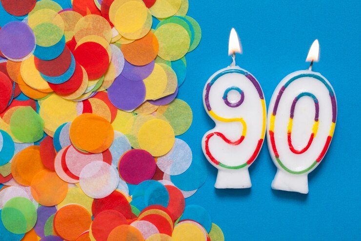Vela de celebración número 90 con confeti de fiesta