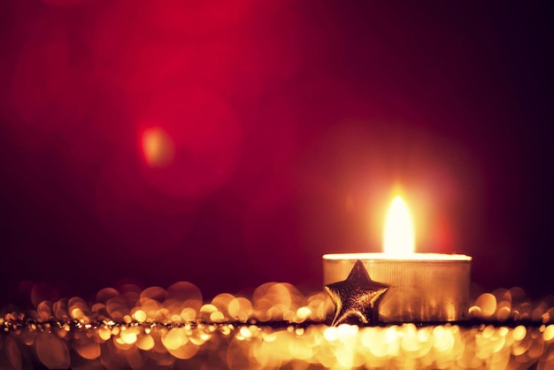 Vela de luz de chá de Natal Bokeh decoração desfocada dourada