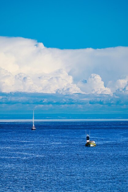 Foto vela navegando en el mar contra el cielo azul