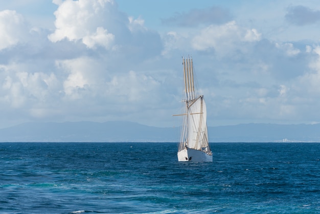 Foto velero con cuatro velas blancas.