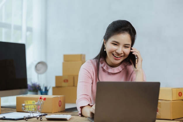 El vendedor de la tienda en línea está hablando con los clientes que hacen un pedido para confirmar su pedido antes de empacar y enviar con una empresa de envío privada Idea de abrir una tienda en línea y empacar productos