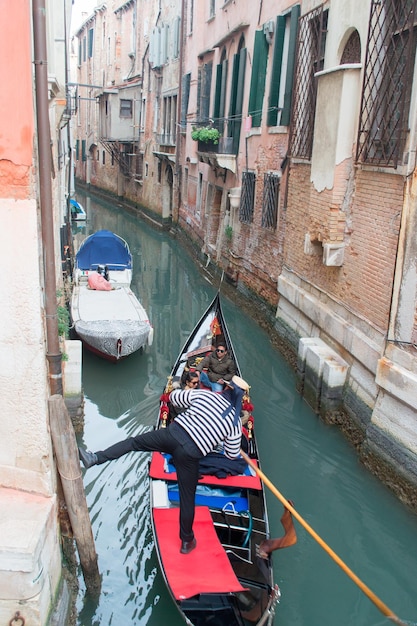 VENEDIG ITALIEN 9. DEZEMBER 2013 Gondoliere und Touristen in einem Kanal in Venedig