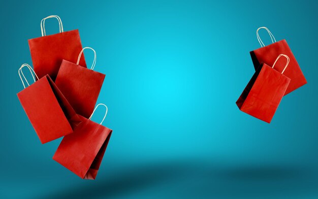Venta caliente Bolsas de compras rojas en el aire en un fondo de gradiente azul espacio para el texto