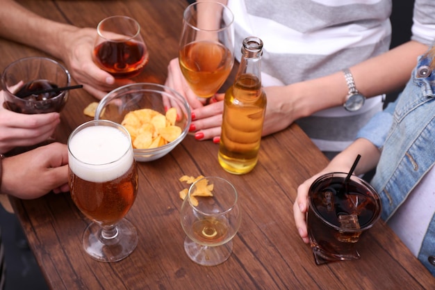 Ver a amigos tomando bebidas alcohólicas en el primer plano del bar