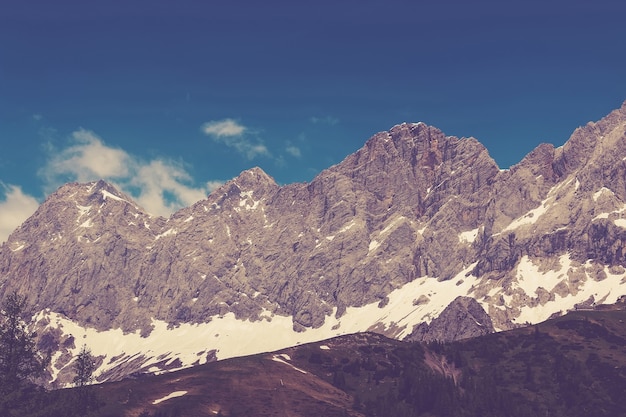 Ver de cerca las montañas alpinas en el parque nacional Dachstein, Austria, Europa. Cielo azul y bosque verde en día de verano