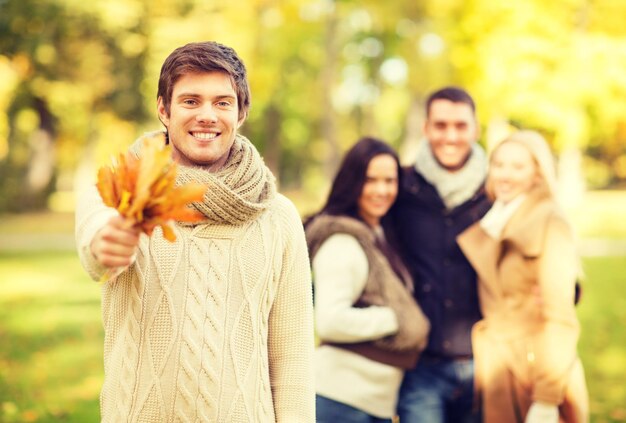 verano, vacaciones, vacaciones, concepto de gente feliz - grupo de amigos o parejas divirtiéndose en el parque de otoño