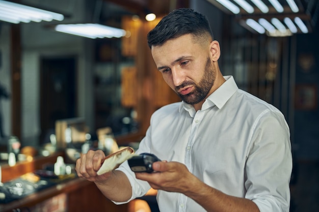 Verantwortlicher Friseur, der seine professionellen Werkzeuge für jeden Kunden sauber hält