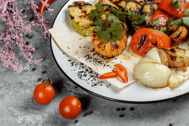 Verduras asadas en un plato blanco. Verduras frescas a la parrilla