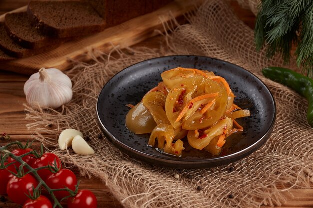 Verduras en escabeche en placa en el blanco de madera