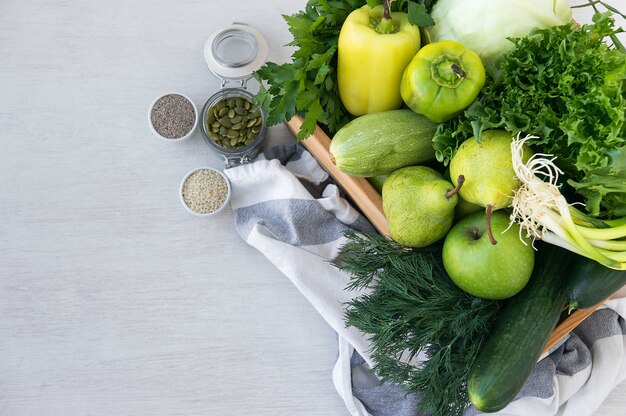 Verduras hipoalergénicas verdes en caja de madera y las semillas. Comida vegetariana. Enfoque selectivo, vista superior