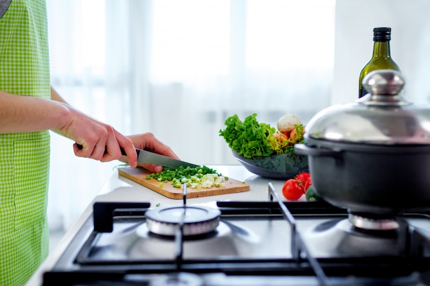 Verduras picadas en la tabla de cortar para platos de verduras y ensaladas frescas en la cocina en casa. Preparación de cocina para la cena. Alimentos limpios y saludables y una nutrición adecuada.