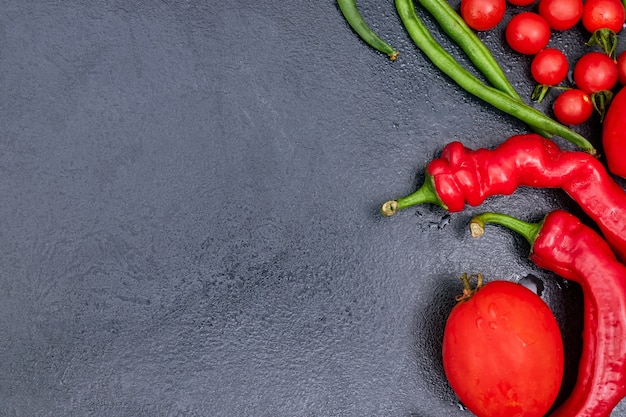 Verduras rojas en un espacio de copia de mesa negra