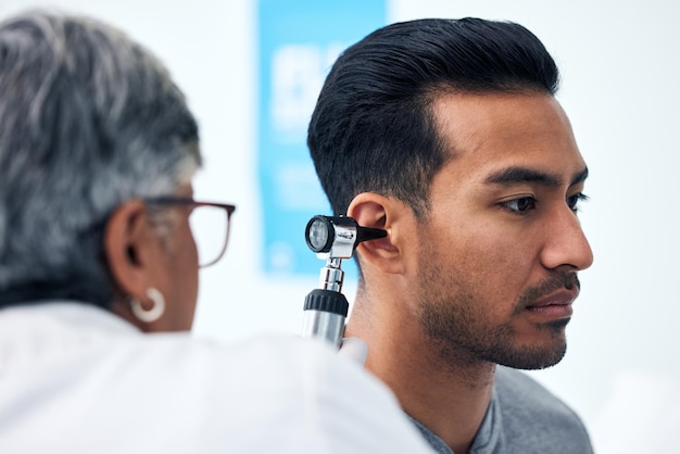 Foto verificador de ouvido e médico otorrinolaringologista com consulta de paciente para audição e bem-estar no hospital funcionário sênior e teste de otoscópio de médico com trabalho de saúde e exame de consultoria com especialista