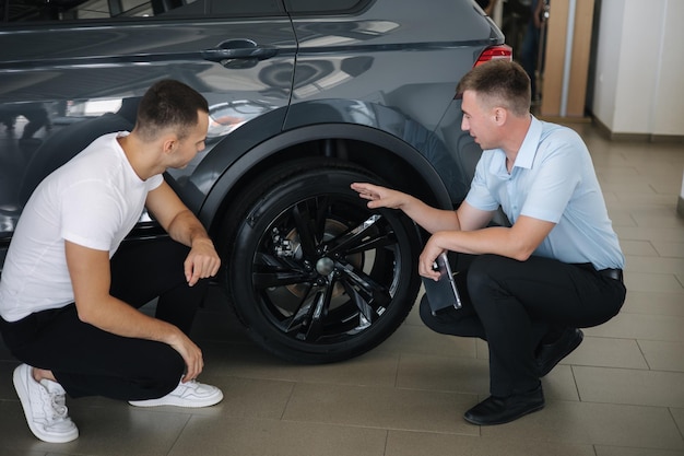 Verkäufer, der Autos im Autohaus verkauft, Mann, der Auto im Autohaus auswählt, zeigen die Größe der