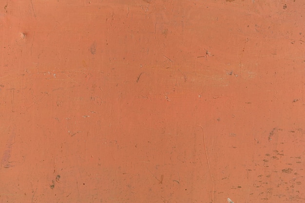 Verputzte Ziegelwand gemalt im orangefarbenen Weinleseartstilhintergrund und -beschaffenheit.