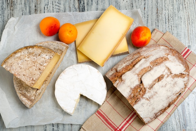 Verschiedene französische Käsesorten mit Brot und Aprikosen