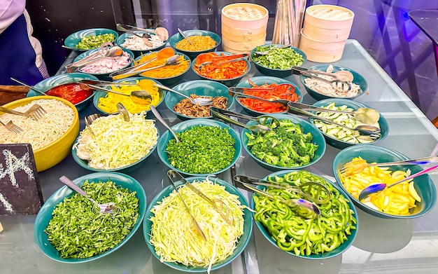 Verschiedene Gemüsesalate in Schüsseln auf einem Markt in Thailand