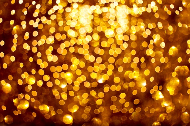 Verschwommene goldene Lichter auf schwarzem Hintergrund Festliches Muster für Ihr Design
