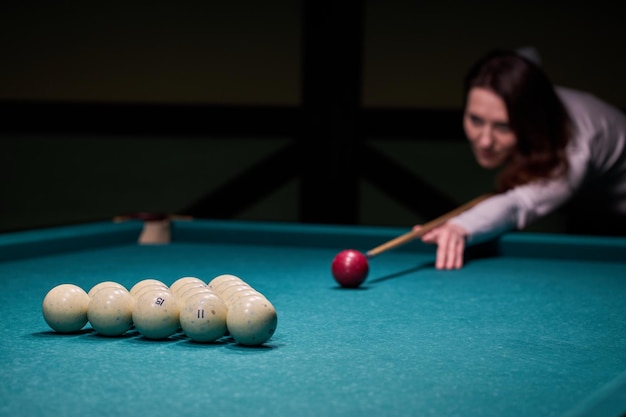 Verschwommene Silhouette eines Mädchens, das im Club Billard spielt