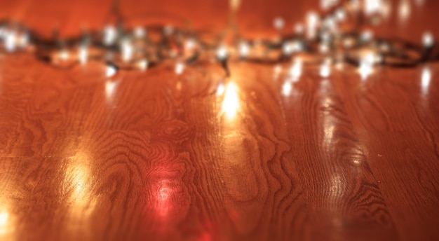 Verwischen Sie Weihnachtslichter auf Holzbodenkopienraum