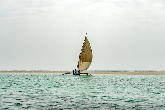 viagem África Quênia e Zanzibar paisagem marítima com águas cristalinas turquesa e paisagem de barco de vela tradicional da praia de Diani