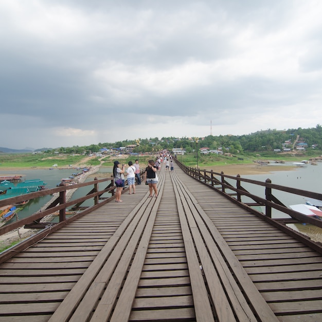 Foto viajante atravessando mon bridge em sangklaburi. kanchanaburi, tailândia