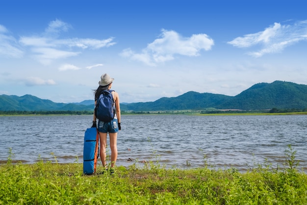 viajante de mulher em pé perto do lago na montanha