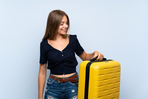 Viajero mujer rubia con maleta con expresión feliz