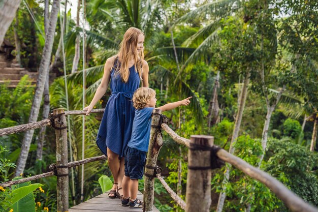 Viajeros de madre e hijo en el punto de vista en el fondo de una jungla, Bali, Indonesia.